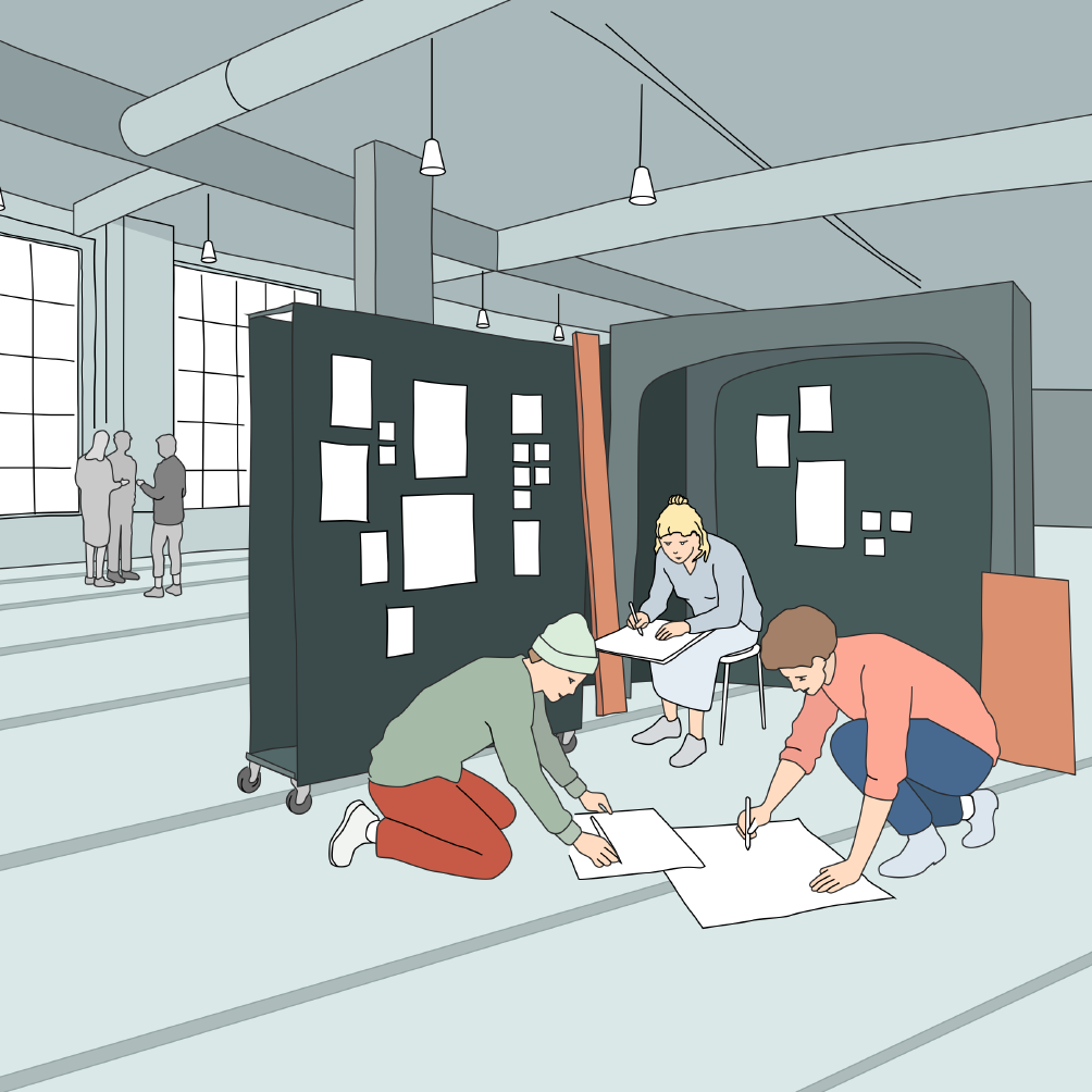 Three people in a workshop space: two kneeling on the floor sketching on large sheets of paper, one sitting at a pinboard covered in notes and sketches.